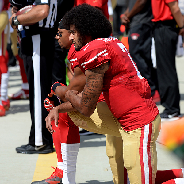 San Francisco 49ers quarterback Colin Kaepernick, front, and safety Eric Reid, back left, kneel during the playing of the national anthem on Sunday, Sept. 18, 2016 at Bank of America Stadium in Charlotte, N.C. (Jeff Siner/Charlotte Observer/TNS)