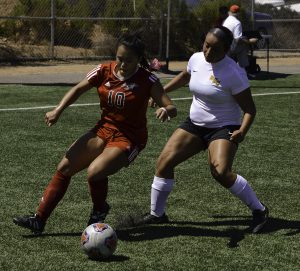 Palomar midfielder Adriana Gutierrez (#10) tries to keep the ball in bounds on Minkoff Field. Despite her goal in the 63rd minute and 2 others by Palomar forward Grace Busby, Palomar was defeated 4-3 by Golden West College on Sept 9, 2016. Eric Szaras/The Telescope