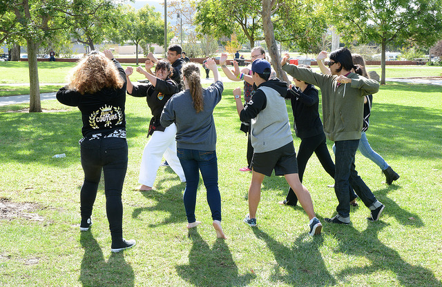 Self defense instructor Chris Brant demonstrates self defense moves during a self defense workshop in the Quad grass during PTSD and Domestic Violence Awareness Week on Tuesday, Nov. 3. 2015. (Yvette Monteleone/The Telescope)