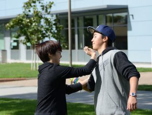Palomar students, Sydney and Casey Williams, practice self defensive moves at a self defense workshop in the Quad grass during PTSD and Domestic Violence Awareness Week on Tuesday, Nov. 3. 2015. ©Yvette Monteleone/The Telescope.