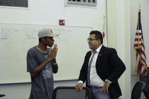 Palomar associate student government vice president, David Aguilar, interacting with spectator Samuel Mbagwu, during a public ASG meeting in SU- 204 on Sept. 23. Idmantzi Torres/ The Telescope .