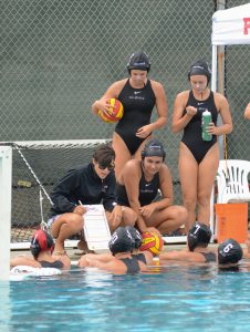 Palomar Head Coach Jackie Puccino discusses strategic moves with her players during a time-out on Sept. 26. Palomar played Southwestern College at Wallace Memorial Pool and defeated them 19-1. Tracy Grassel/The Telescope
