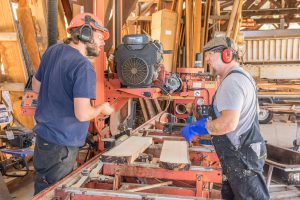The Palomar College Cabinet and Furniture Technology Department students Brett Ritchey and Liam Liedorff inspect the newly sawn planks. October 20, 2016. Joe Dusel/ The Telescope