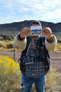 Photography student Irwin Sanchez holding one of his polaroids. Oct. 11. Brianna Dice/The Telescope