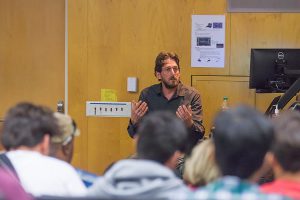 Photojournalist Matt Black, guest speaker for the Media Studies Open House, discusses his work in an auditorium at Palomar College on Nov. 14. Joe Dusel / The Telescope.