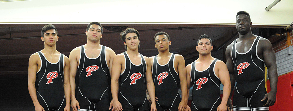 Members of Palomar's wrestling team, Alberto Garcia, Alex Gomez, Chris Kimball, Josh Lawson, Braulio Banuelos, and Seville Hayes pose in the wrestling practice room at Palomar College after a victorious 2016 fall season on Nov. 18, 2016. (Idmantzi Torres/ The Telescope)