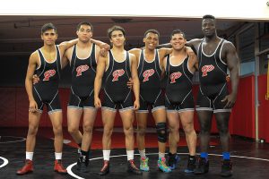 Members of Palomar's wrestling team, Alberto Garcia, Alex Gomez, Chris Kimball, Josh Lawson, Braulio Banuelos, and Seville Hayes pose in the wrestling practice room at Palomar College after a victorious 2016 fall season on Nov. 18. Idmantzi Torres/ The Telescope.