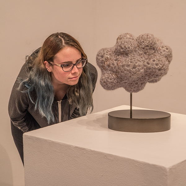 Palomar student Raven Russell examines some of the art on display at the Boehm Gallery on Feb. 9. The show, Let The Light in Glass features the work of artists from the Pacific Northwest and runs from Feb. 9 through March 7. Joe Dusel / The Telescope.