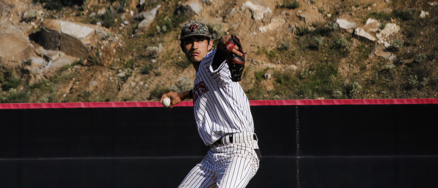 A malel Palomar baseball players gets ready to throw a baseball with his right hand while his left mitted hand is in front of him.
