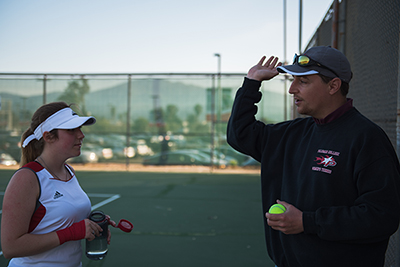 Coach Tissot offers advice to Nicole Burns in between her match sets. Raul Aguilar/The Telescope.