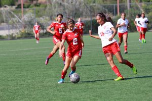 Samantha Kaye-Toral keeps the ball away from Santa Ana's Mayra De La Cruz as she heads towards the goal on Sept. 1. at Minkoff Field. The final score was 2-1, in favor of Santa Ana. Alexis Szedlacsek / The Telescope