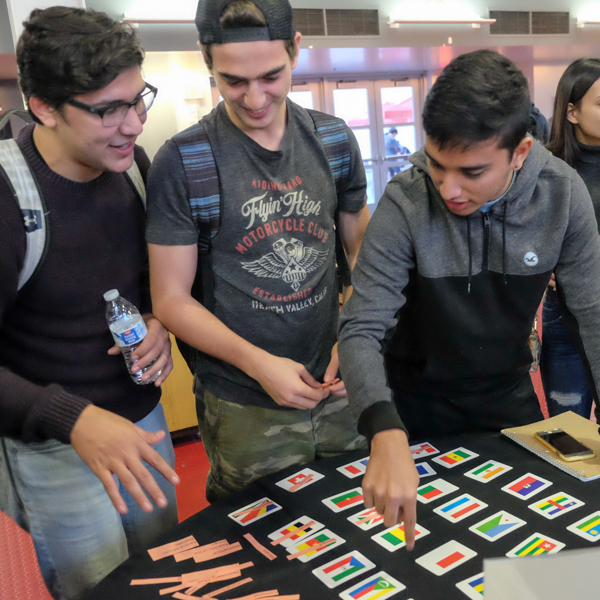 Nicolas Andrade, Alexandre Timonian, and Santiago Diacono (l-r) try to identify the flags of French-speaking nations during Language and Culture Day at Palomar College, Nov. 29, 2017. (Scott Engrav/The Telescope)