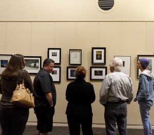 Students and teachers alike observe Palomar student’s photographs at Enlightened Lens Exhibit in the Harth Gallery at San Marcos Civic Center. Jennesh Agagas / The Telescope