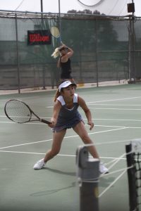 Womens palomar tennis player Eren Sugimoto attempts a drop shot from opposing Grossmont College player. Susanna Behnan/The Telescope