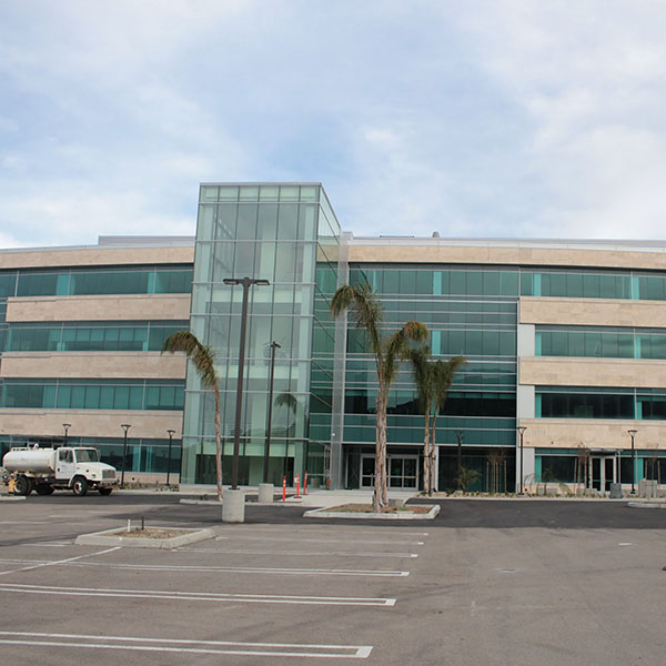 The entrance to the Palomar College South Education Center in Rancho Bernardo. It is three stories tall with a stairwell that is made mostly of glass.
