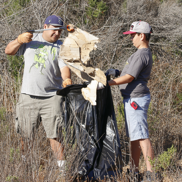 Father, Matt Milla and Son, Isaac Milla volunteer to pick up trash at the I Love A Clean San Diego event in San Marcos, Sept. 15, 2018. (Kimberly Barber/The Telescope)