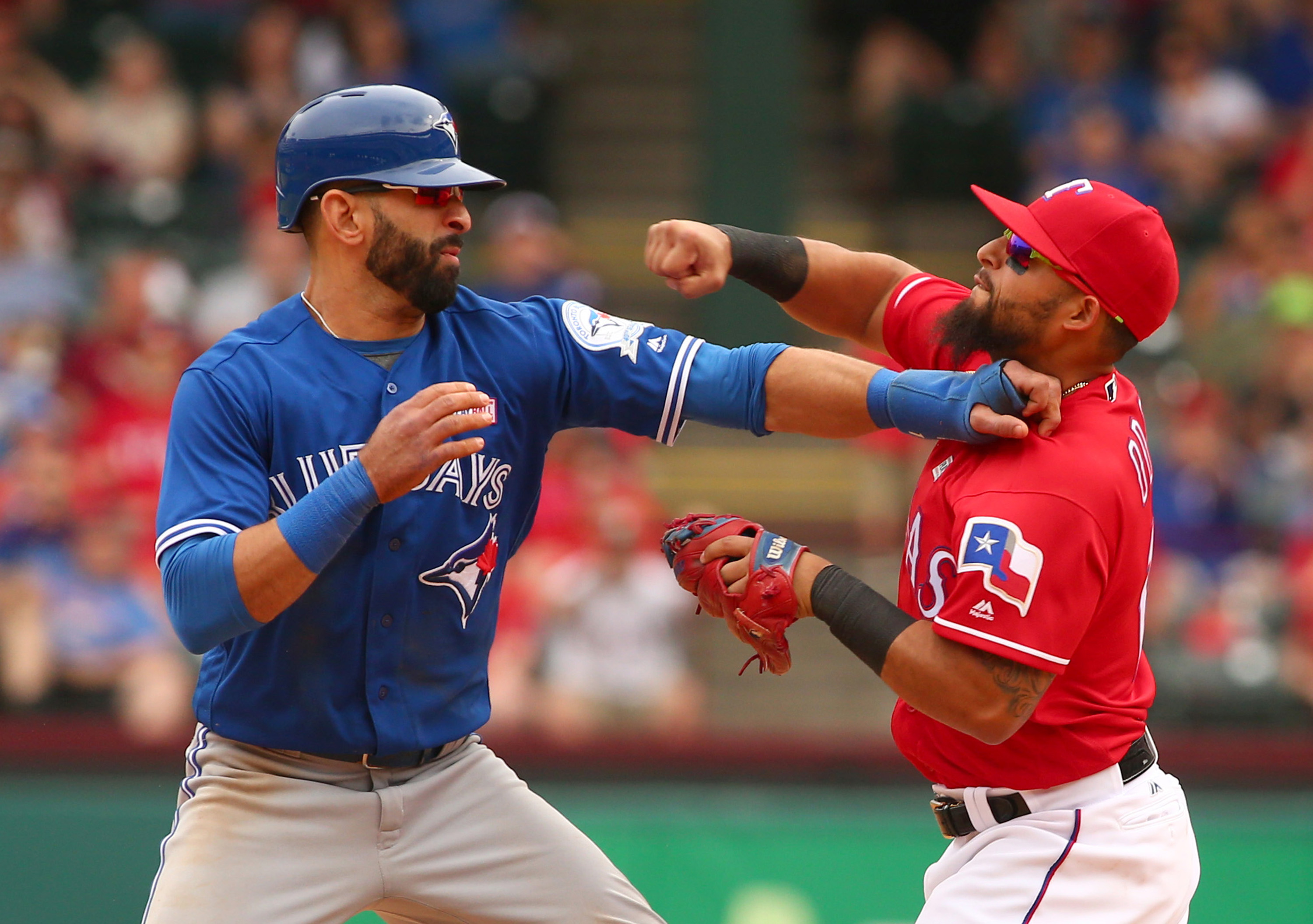 Toronto Blue Jays Jose Bautista (19) gets hit by Texas Rangers second baseman Rougned Odor (12) after Bautista slid into second in the 8th inning at Globe Life Park on May 15, 2016 in Arlington, Texas. The Rangers won 7-6. (Richard W. Rodriguez/Fort Worth Star-Telegram/TNS)