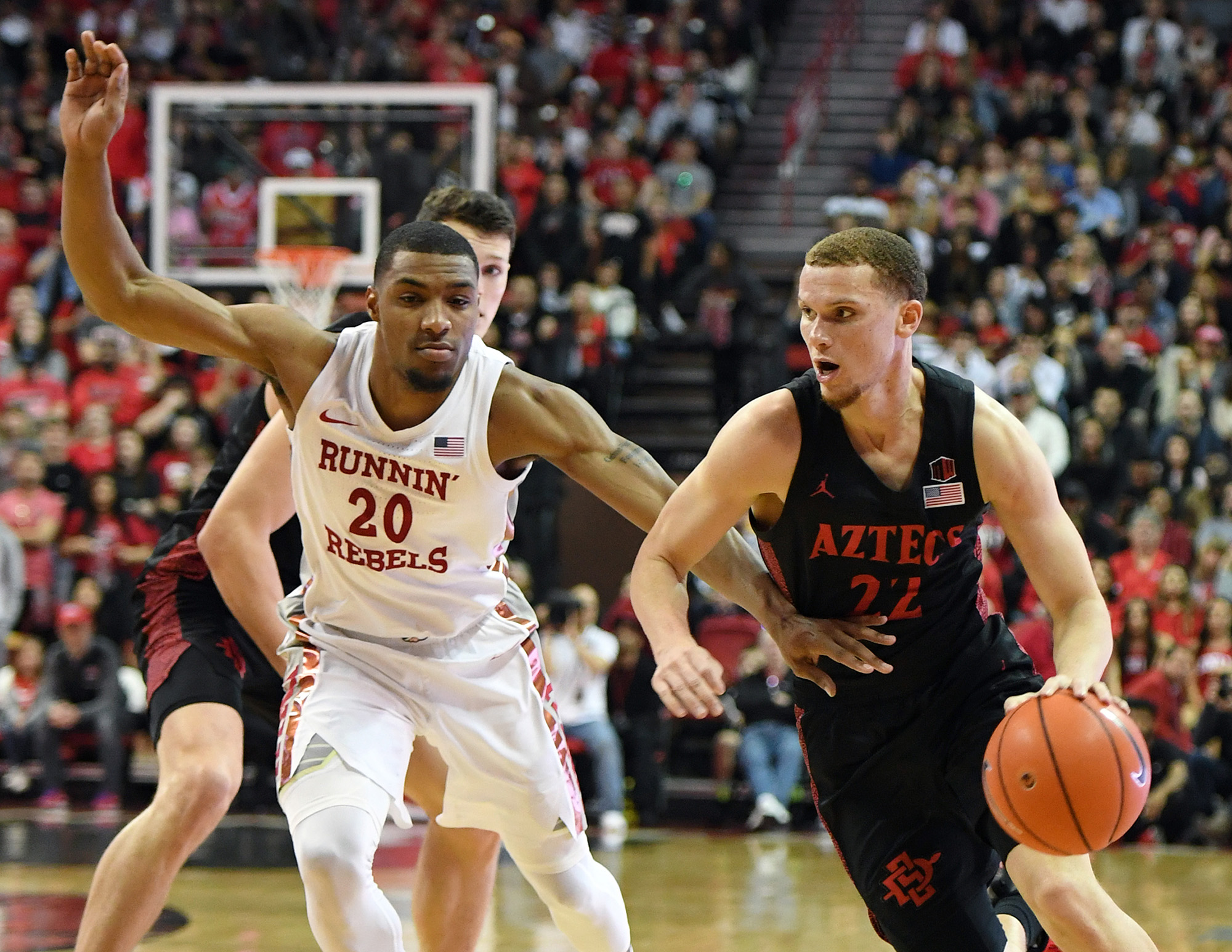 Malachi Flynn (22) of the San Diego State Aztecs drives against Nick Blair (20) of the UNLV Rebels on Sunday, Jan. 26, 2020 at the Thomas & Mack Center in Las Vegas, Nev. The Aztecs defeated the Rebels 71-67. (Ethan Miller/Getty Images/TNS)
