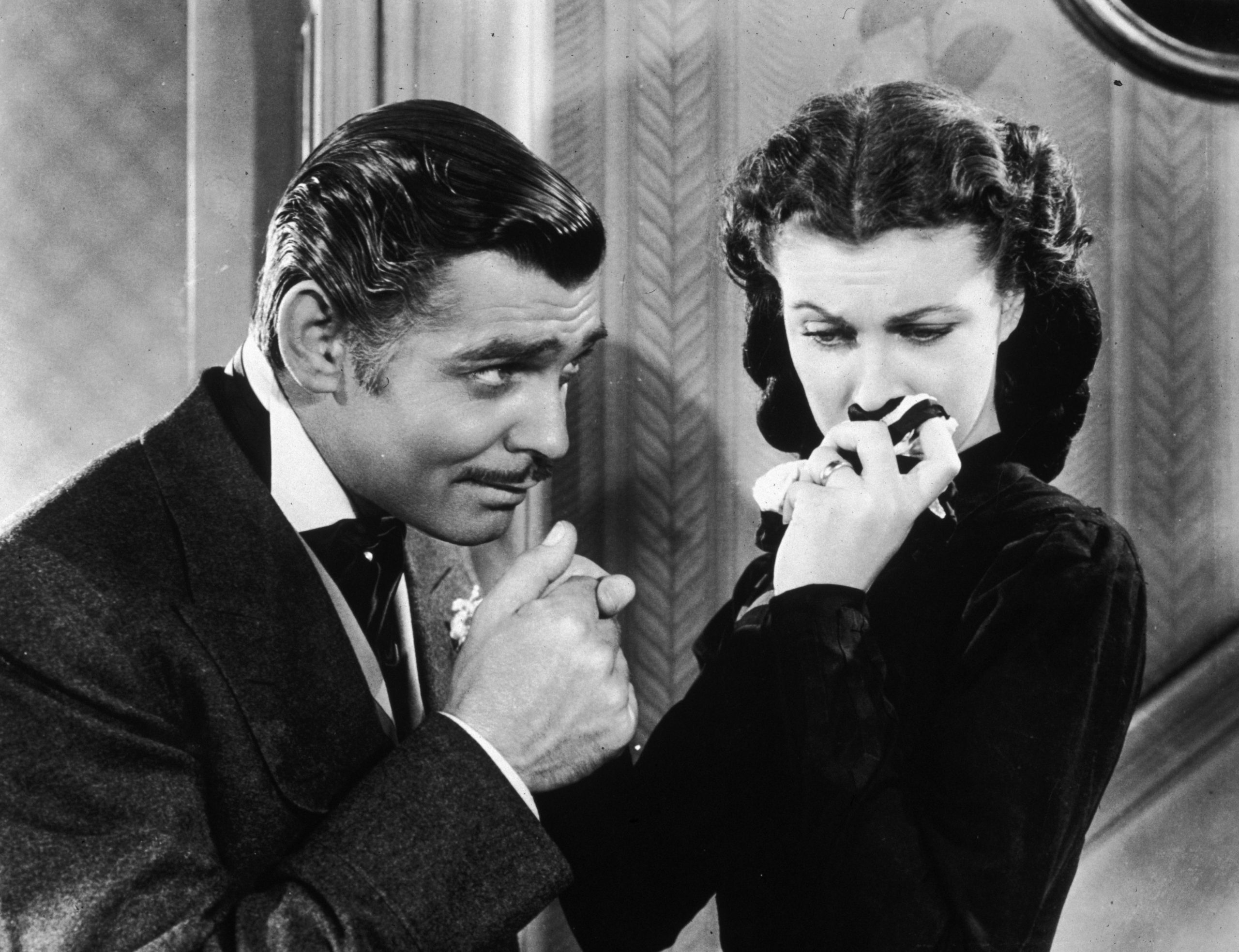 Actor Clarke Gable (left) holds actress Viven Leigh's hand in the film "Gone with the Wind" in 1930.