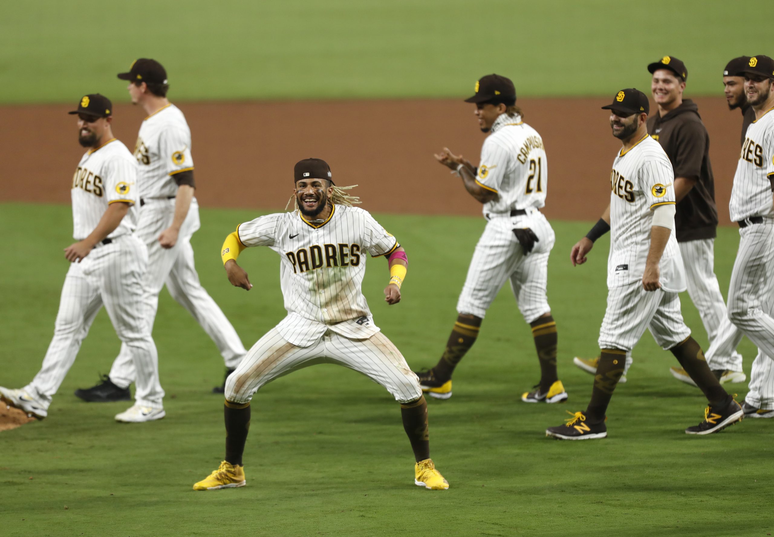 San Diego Padres infielder Fernando Tatis Jr., middle, celebrates after a series-clinching 4-0 win against the St. Louis Cardinals in Game 3 of the National League Wild Card series at Petco Park in San Diego on Friday, Oct. 2, 2020. (K.C. Alfred/San Diego Union-Tribune/TNS)