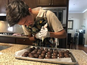 Matthew Wang making truffles for his fundraiser. Photo credit: Matthew Wang