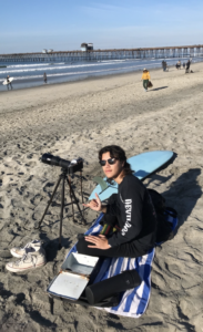 Alex Ortega at the beach with his camera and tripod.