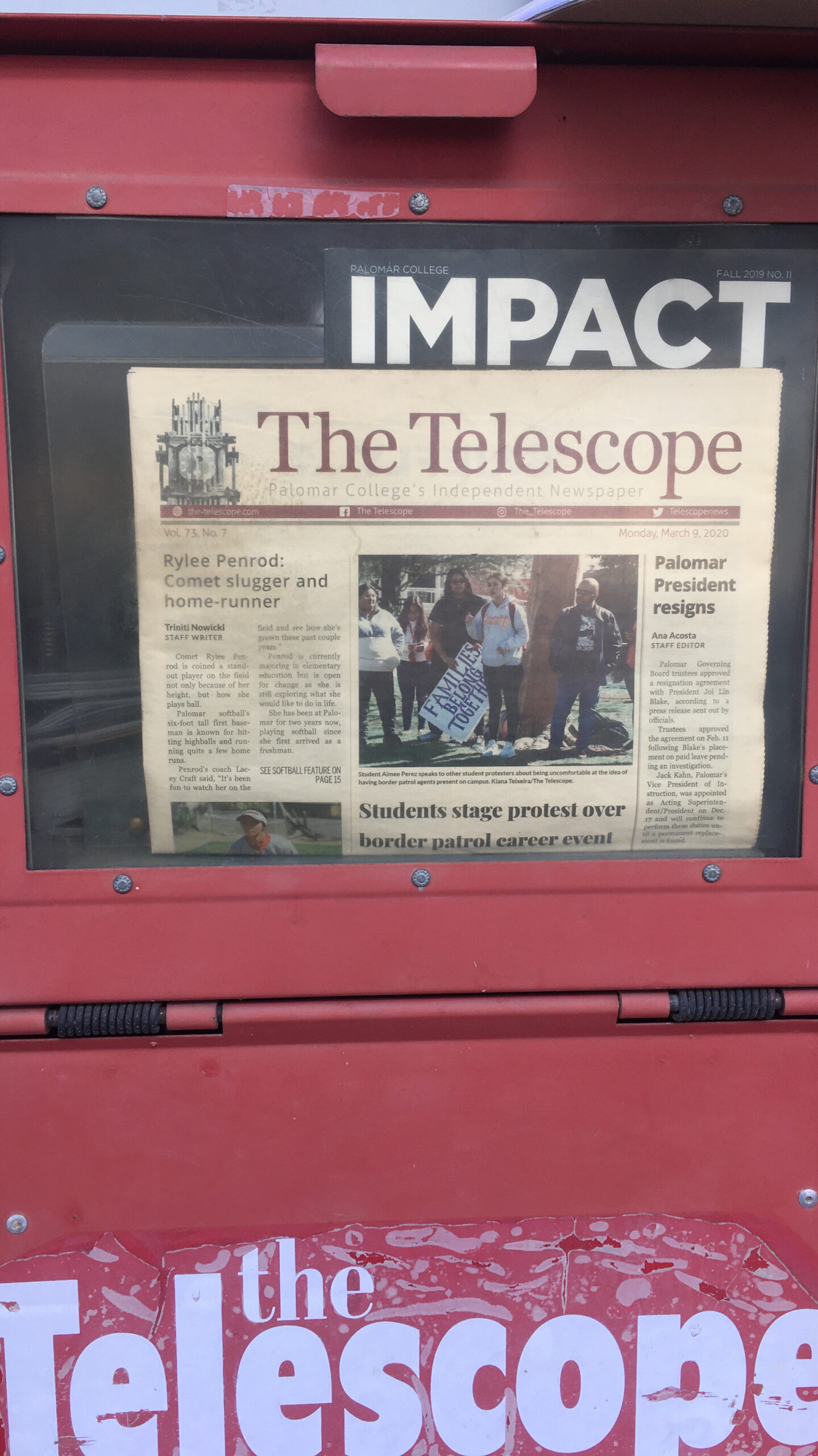 A Telescope newspaper displays inside a red newspaper bin.
