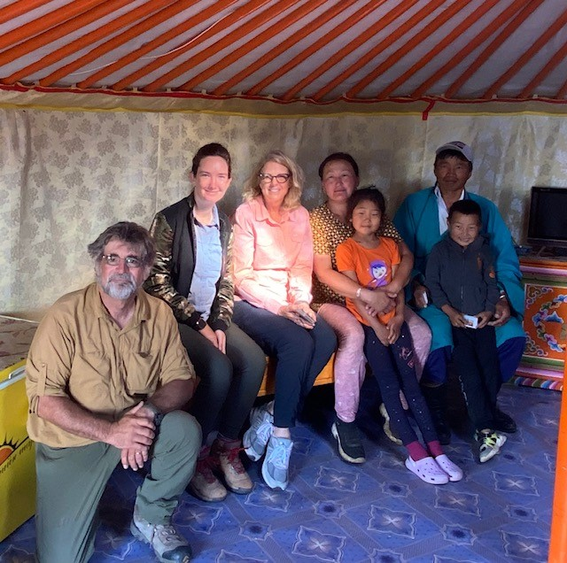 Palomar student and professors seated with a Mongolian family
