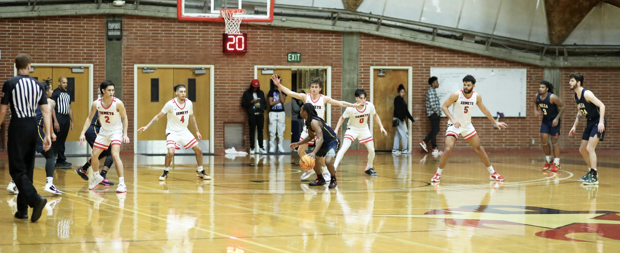 A group of Palomar basketball players play defense against the Mesa College team in The Dome.