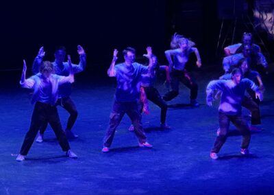 dancers performing in blue light