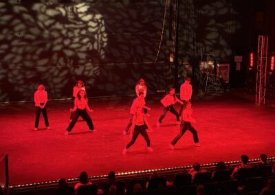 dancers performing in red light