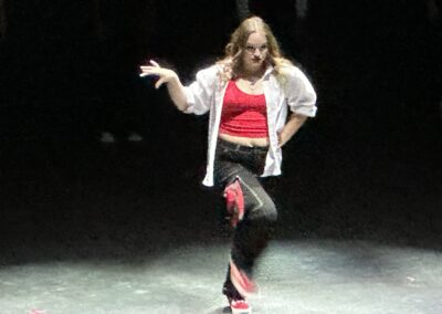 woman in red, white, and black dancing on stage