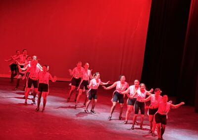 dancers performing on stage on red light