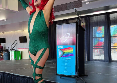 Drag Queen with red hair and green dress performing