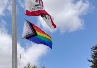 US, California, and Pride flags raised