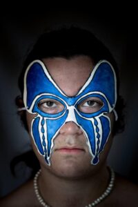 portrait of man with blue and white face design 