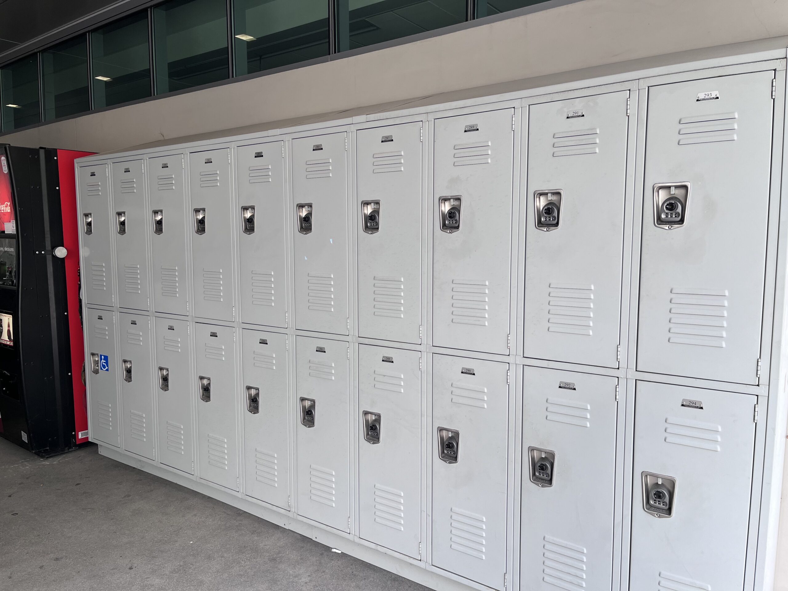 A row of lockers line the wall of a building.