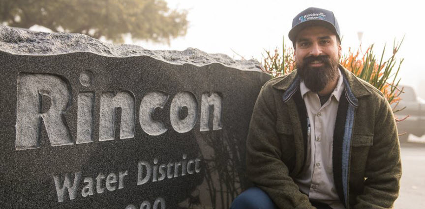 Man in front of the Rincon Water District sign