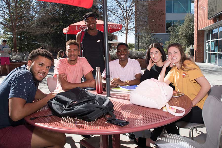 A group of students sitting at a table in the Student Union.