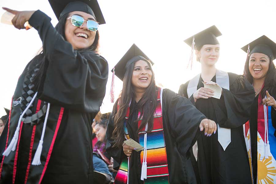 A group of joyful Palomar College graduates.