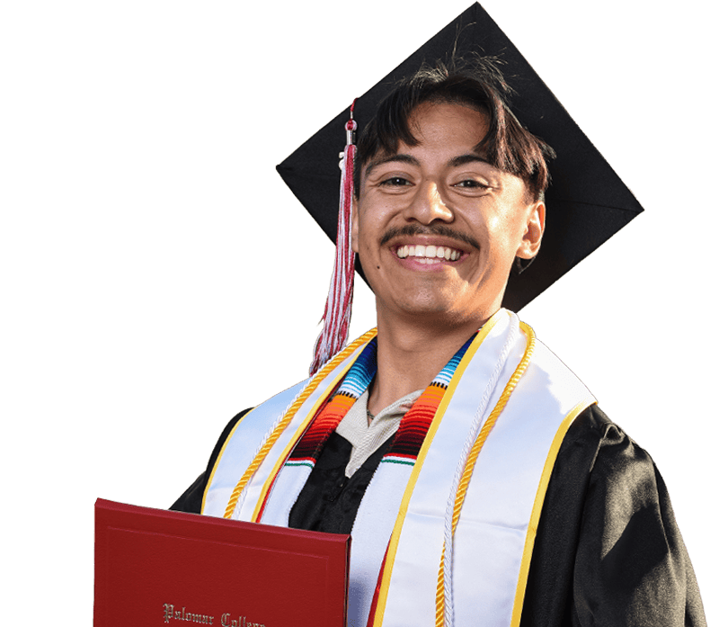 Smiling Palomar College graduate looking at the camera.